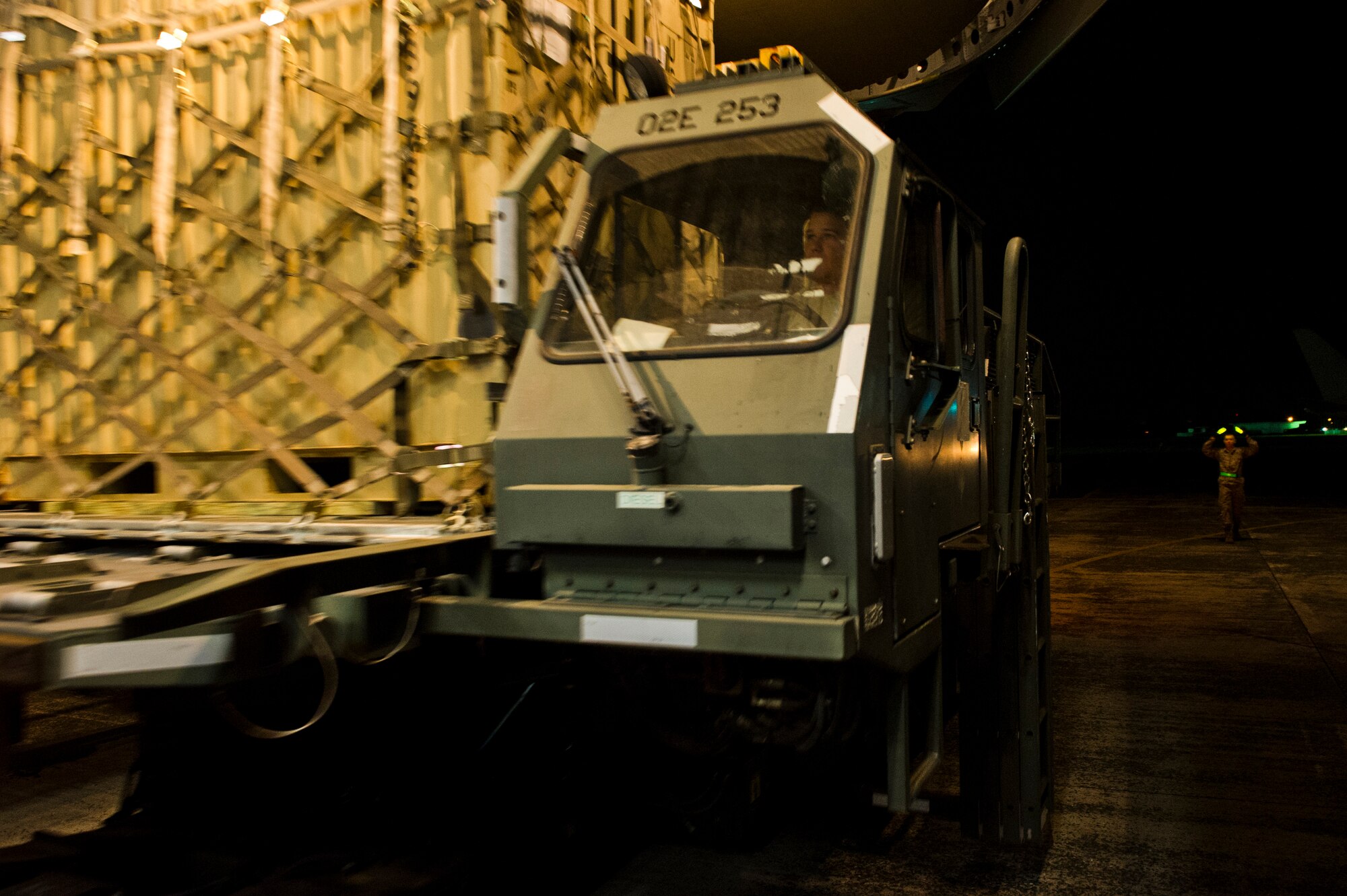 U.S. Air Force Staff Sgt. Christopher Wilkinson, an aerial porter of the Joint Task Force-Port Opening of the 621st Contingency Response Wing stationed at Joint Base McGuire-Dix-Lakehurst, N.J., unloads a pallet from a C-17 Globemaster III with a Halvorsen Loader here, during Operation United Assistance, Nov. 2, 2014. OUA is a Joint Forces Command-led operation to provide command and control, logistics, training and engineering support to the U.S. government’s efforts to contain the Ebola virus outbreak in West African nations. (U.S. Air Force photo by Staff Sgt. Gustavo Gonzalez/Released)