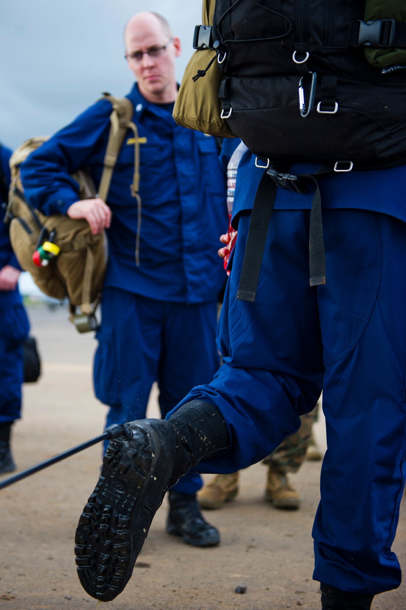 Members of the U.S. Public Health Service cleanse their boots after returning here, during Operation United Assistance, Oct. 31, 2014. OUA is a U.S. Joint Forces Command-led operation to provide command and control, logistics, training and engineering support to the U.S. government’s efforts to contain the Ebola virus outbreak in West African nations. (U.S. Air Force photo by Staff Sgt. Gustavo Gonzalez/Released)