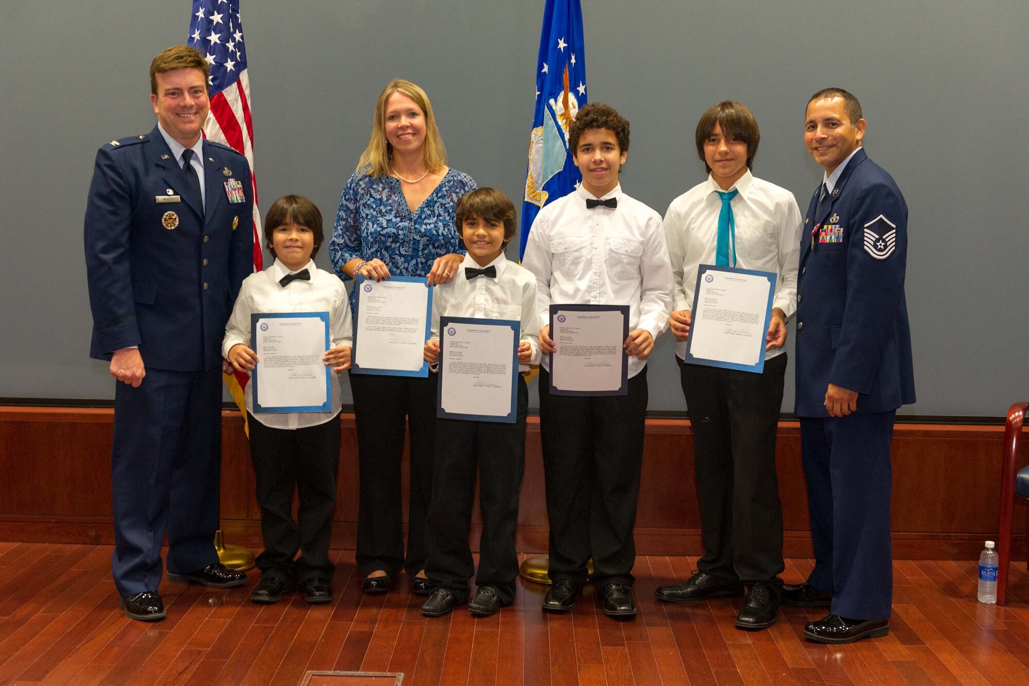 Master Sgt. Thomas Arevalos (right), a heating, ventilation and air conditioning project manager for the Air Force Technical Applications Center, is pictured with his commander,  Col. Chris Worley (left), his wife, Melissa, and their four sons, Lane, Braydon, Gavin and Tommy, at Arevalos' retirement ceremony Oct. 17, 2014.  (U.S Air Force photo by Cory Long)

