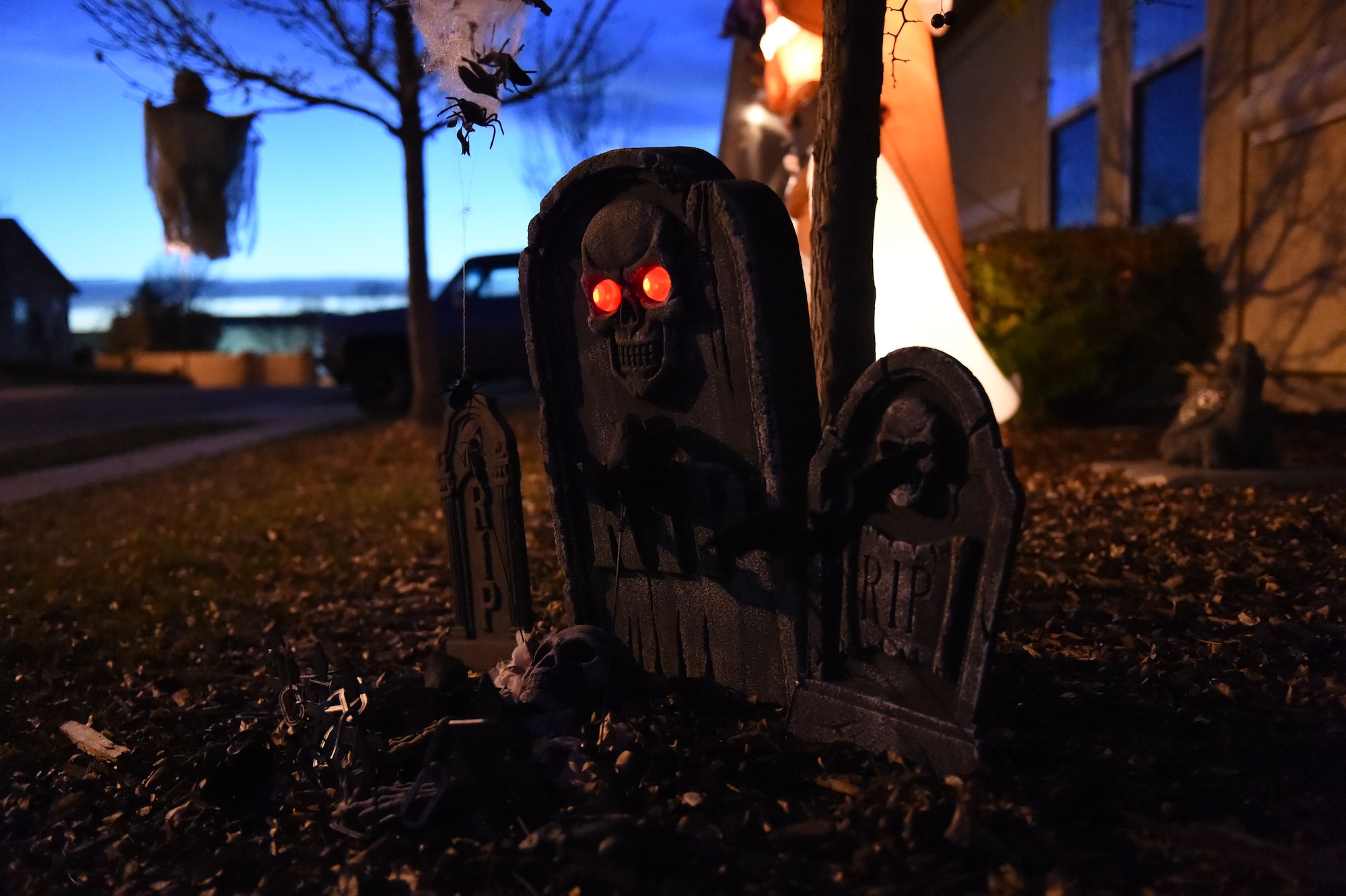 Haunted gravestone decorations are displayed in base housing Oct. 31, 2014, on Buckley Air Force Base, Colo. Members of the 460th Security Forces Squadron and volunteers patrolled base housing during Halloween, providing a safer environment for trick-or-treaters. (U.S. Air Force photo by Airman 1st Class Samantha Saulsbury/Released)