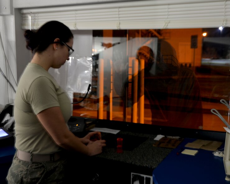 A mysterious shadowy figure looks in the Satellite Pharmacy at Barksdale Air Force Base, La. Since the pharmacy was built over the old Stonwaill Cemetery and many Airmen have told tales of things being moved from one place to another and even empty prescription bottles seemingly thrown out of anger towards them from an unknown source. (U.S. Air Force photo illustration/Airman 1st Class Mozer O. Da Cunha)