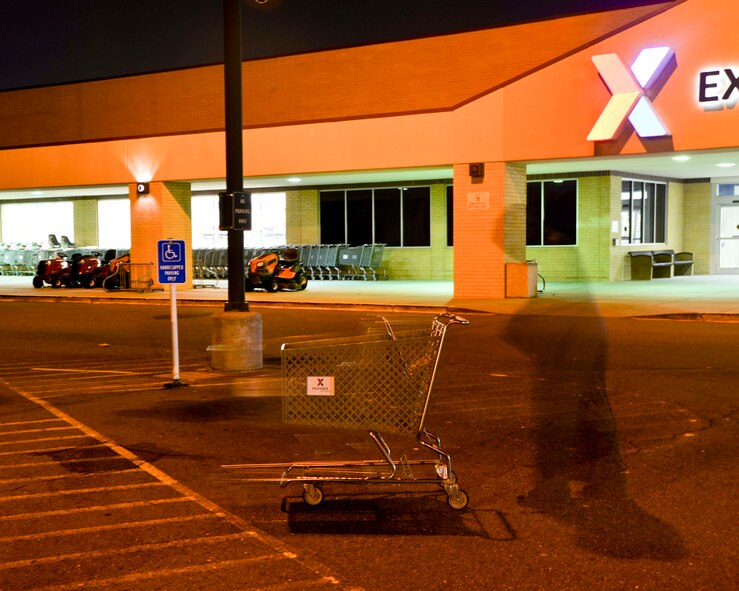 A mysterious shadowy figure lurks through the parking lot of the Exchange at Barksdale Air Force Base, La. The location of the Exchange and Commissary was once the home of the Stonewall Cemetery. (U.S. Air Force photo illustration/Airman 1st Class Mozer O. Da Cunha)