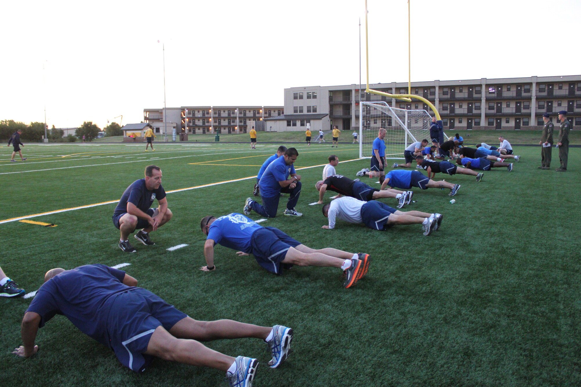 Commanders and chiefs from the 552nd Air Control Wing compete in the push up competition during the Chief and Commander Physical Fitness challenge at the base track Oct. 27. Command teams from the wing, groups and squadrons competed in a combined PT Test to build camaraderie and teamwork in their units. The 552nd Air Control Group team of Chief Master Sgt. Tom Chimenski and Col. Michael Homola took top honors in the challenge. (Air Force photo by Karla Bickley)