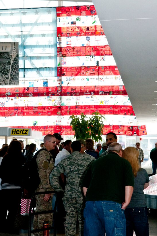U.S. Air Force Airmen assigned to the 307th Security Forces squadron wait with family and friends for their luggage after returning from a six-month long deployment, Oct. 29, 2014, Shreveport, La. The Airmen are stationed at Barksdale Air Force Base, La., and deployed in support of Operation Enduring Freedom. (U.S. Air Force photo by Master Sgt. Dachelle Melville/Released)