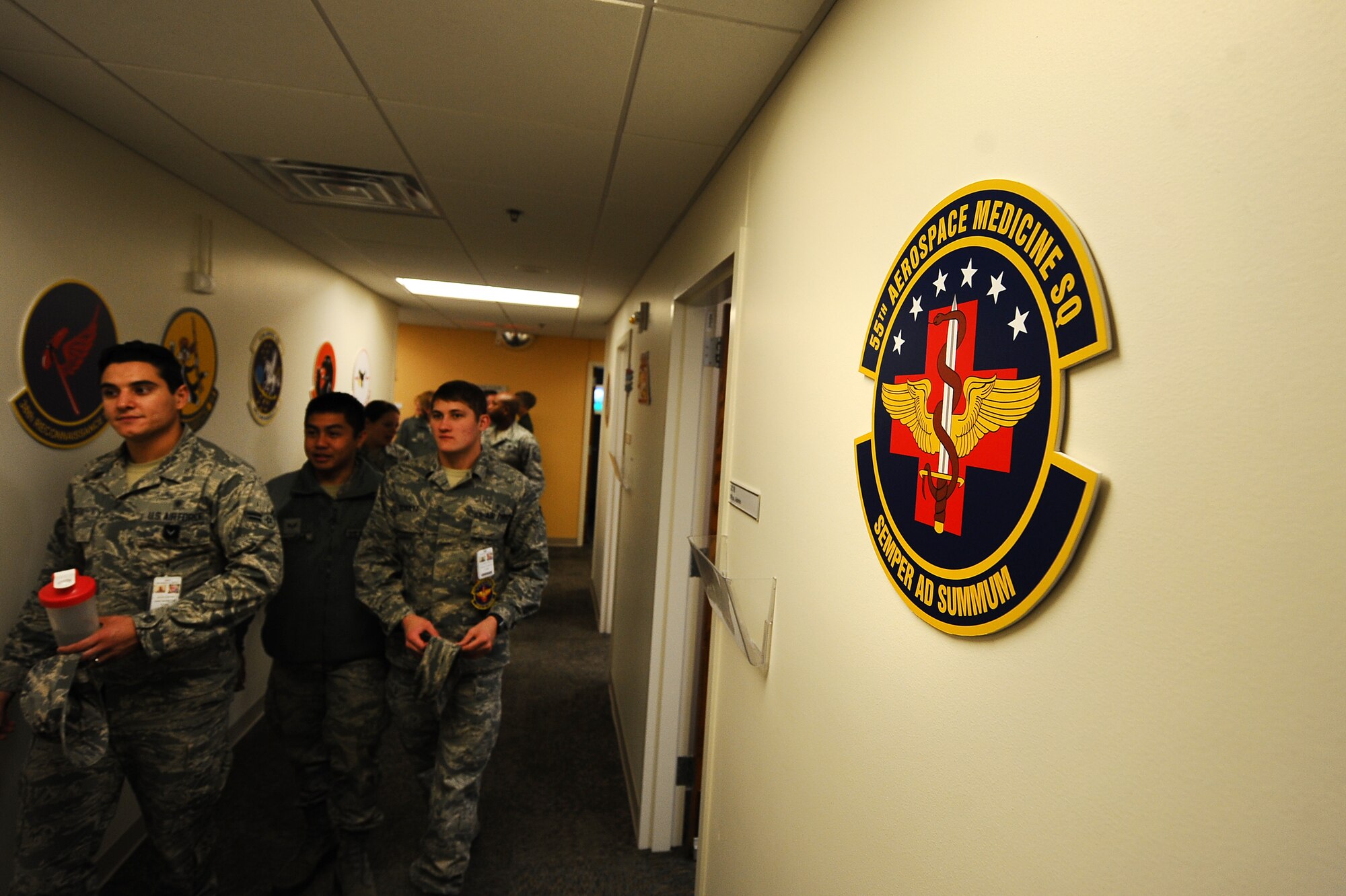 Members of the 55th Aerospace Medicine Squadron walk the halls of their new office location following a ribbon cutting ceremony held at the Ehrling Bergquist Clinic Oct. 29, Offutt Air Force Base, Neb. The 55th Medical Group divided into four separate squadrons in 1994. The 55th Aerospace Medicine Squadron moved behind the gates of Offutt in February 1997. Sixteen years later, the squadron returns to the clinic in order to better spend resources in a newly force-shaped landscape.  (U.S. Air Force photo by Josh Plueger/Released)