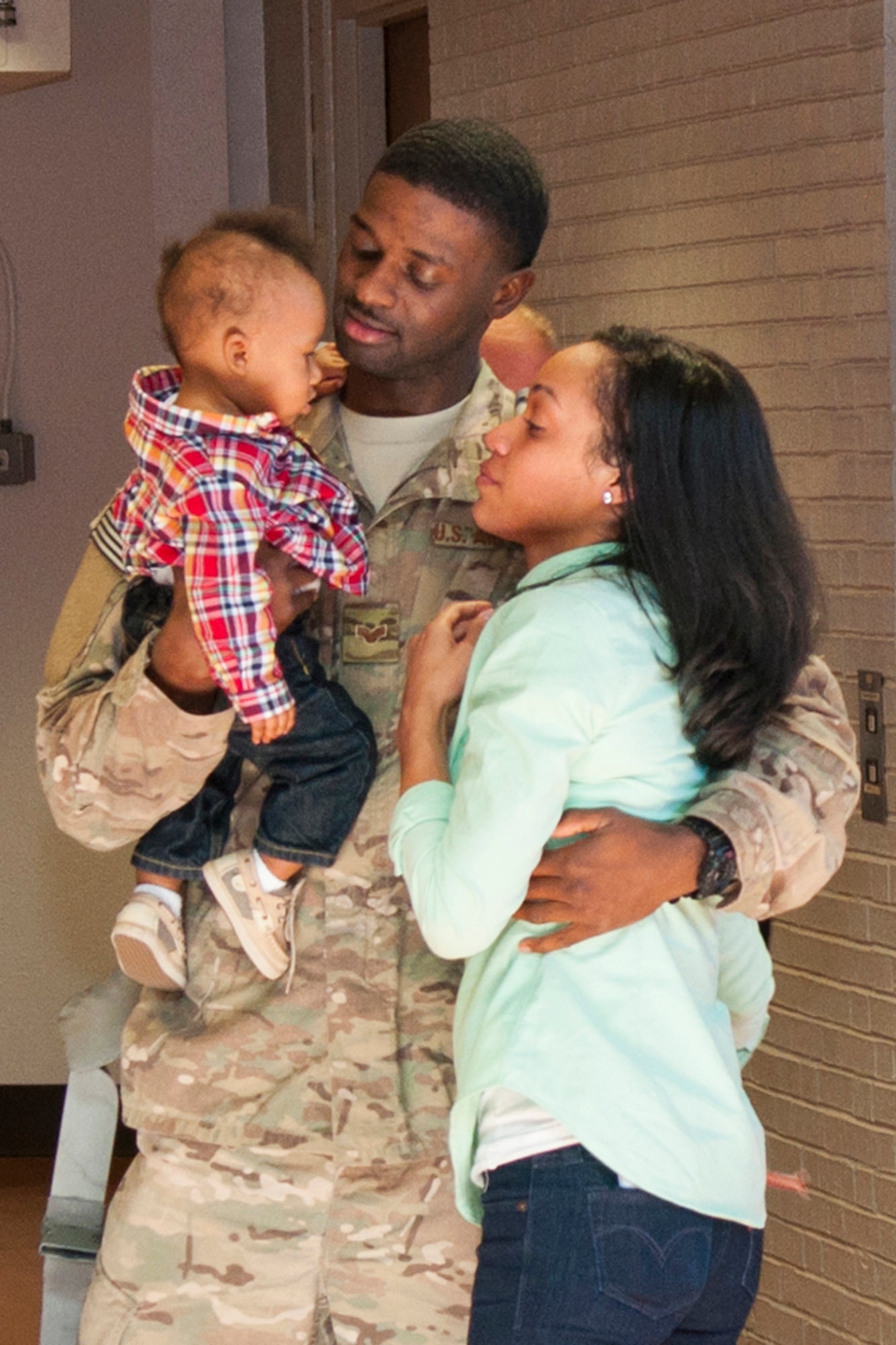 U.S. Air Force Senior Airman Joshua Hill reunites with his family after returning from a six-month long deployment, Oct. 29, 2014, Shreveport, La. Hill is assigned to the 307th Security Forces Squadron at Barksdale Air Force Base, La., and deployed in support of Operation Enduring Freedom. (U.S. Air Force photo by Master Sgt. Dachelle Melville/Released)