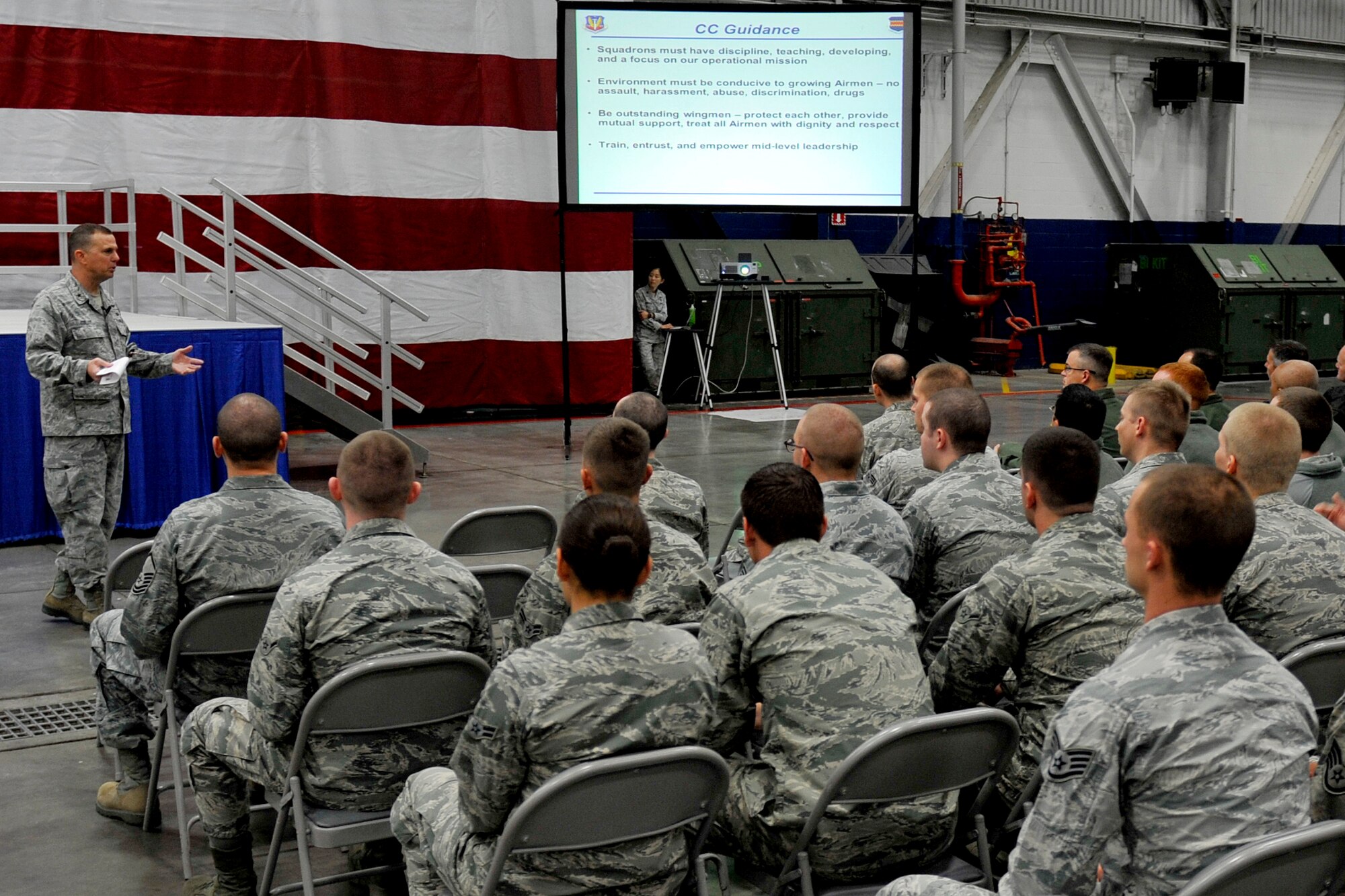 U.S. Air Force Brig. Gen. Gregory Guillot, 55th Wing commander, speaks to members of the 55th Wing during a commander’s call held in Dock 1 of the Bennie Davis Maintenance Facility on Offutt Air Force Base, Neb., Oct. 29. Guillot provided the wing with guidance on developing Airmen and creating an environment where Airmen can grow. (U.S. Air Force photo by Jeff W. Gates/Released)