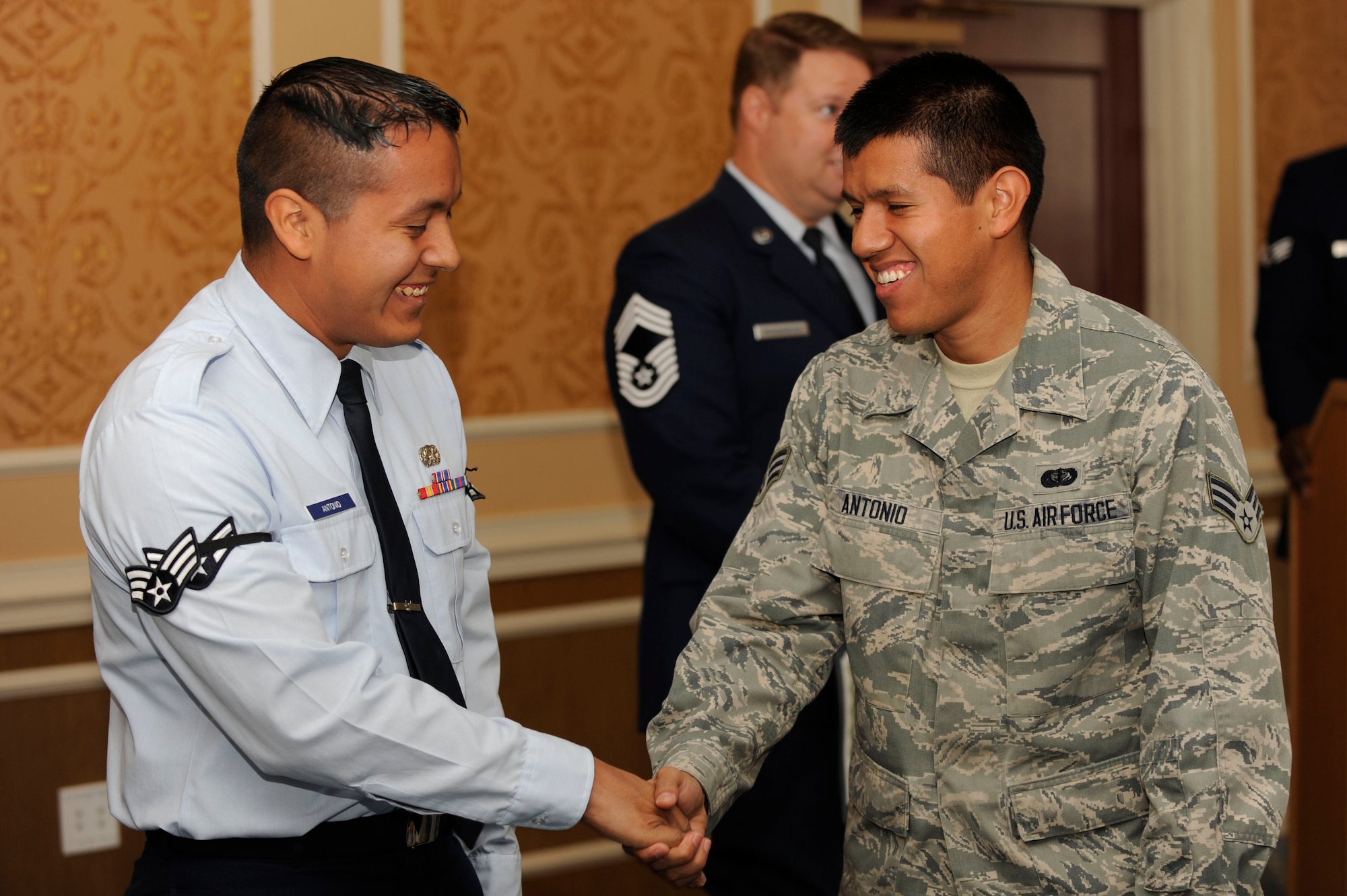 U.S. Air Force Senior Airman Juan Antonio, 633rd Force Support Squadron services apprentice, right, congratulates newly promoted Senior Airman Antonio Antonio, 439th Supply Chain Operations Squadron A-10 Thunderbolt II mission capable technician, during a promotion ceremony at Langley Air Force Base, Va., Oct. 31, 2014. Airmen who are awarded senior airman below-the-zone are nominated by their leadership to promote six months early. (U.S. Air Force photo by Staff Sgt. Natasha Stannard/Released) (This photo was cropped)
