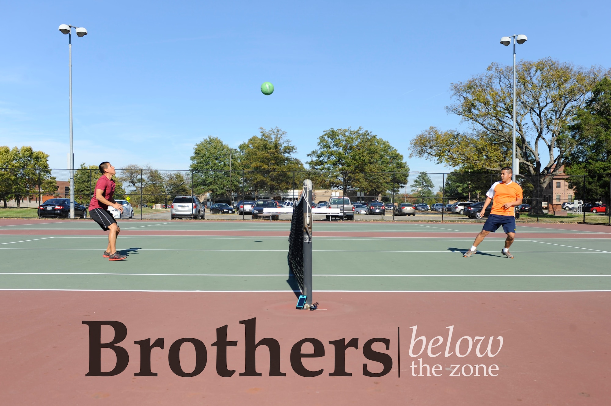 U.S. Air Force Senior Airman Juan Antonio, 633rd Force Support Squadron services apprentice, left, plays tennis-soccer with his brother, Airman 1st Class Antonio Antonio, 439th Supply Chain Operations Squadron A-10 Thunderbolt II mission capable technician, at Langley Air Force Base, Va., Oct. 28, 2014. The brothers joined the Air Force together and received orders to the same base for their first duty assignments. (U.S. Air Force photo illustration by Staff Sgt. Natasha Stannard/Released) (This photo was cropped and levels were changed. Text was also added to the photo)