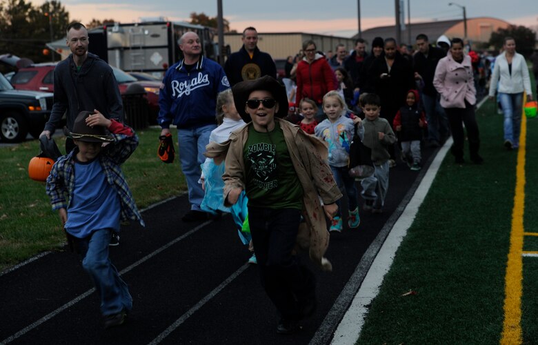 Military families walk and run during the Zombie Apcalypse Run on Joint Base Andrews, Md, Oct. 30, 2014. Military Families around the National Capital Region were invited to attend “Trunk or Treat” and the Zombie Apocalypse Run in celebration of Halloween.  (U.S. Air Force photo/ Senior Airman Nesha Humes)