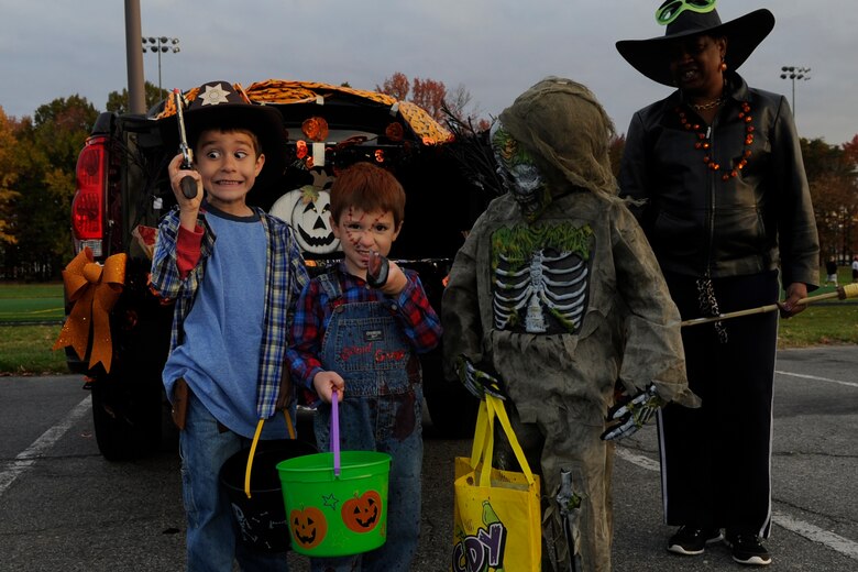 Trunk or Treat participants pose for a photo at the Military Personnel Squadron track at Joint Base Andrews, Md., Oct. 30, 2014. Participants dressed up in costumes, parked cars in an open lot and decorated car trunks to hand out candy and Halloween toys to military families. (U.S. Air Force photo/ Senior Airman Nesha Humes)