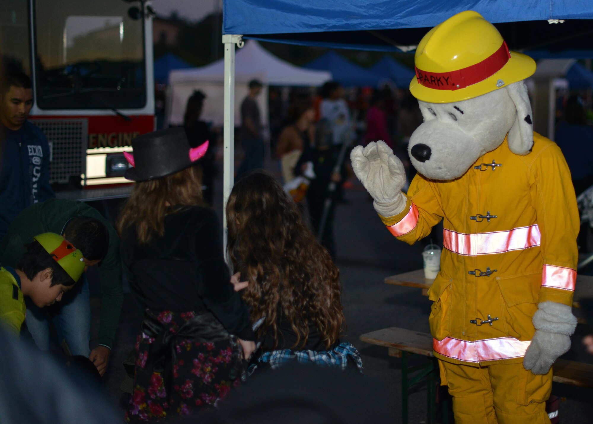 Sparky the Fire Dog waves at children during Fall Fest, November 1, 2014, at Aviano Air Base, Italy. Fall Fest offered Department of Defense cardholders and their families a chance to celebrate Halloween in a fun and safe environment. While at Fall Fest, families enjoyed trick-or-treat-booths, food stands, a costume parade and carnival games.  (U.S. Air Force photo/Tech. Sgt. Eric Donner)