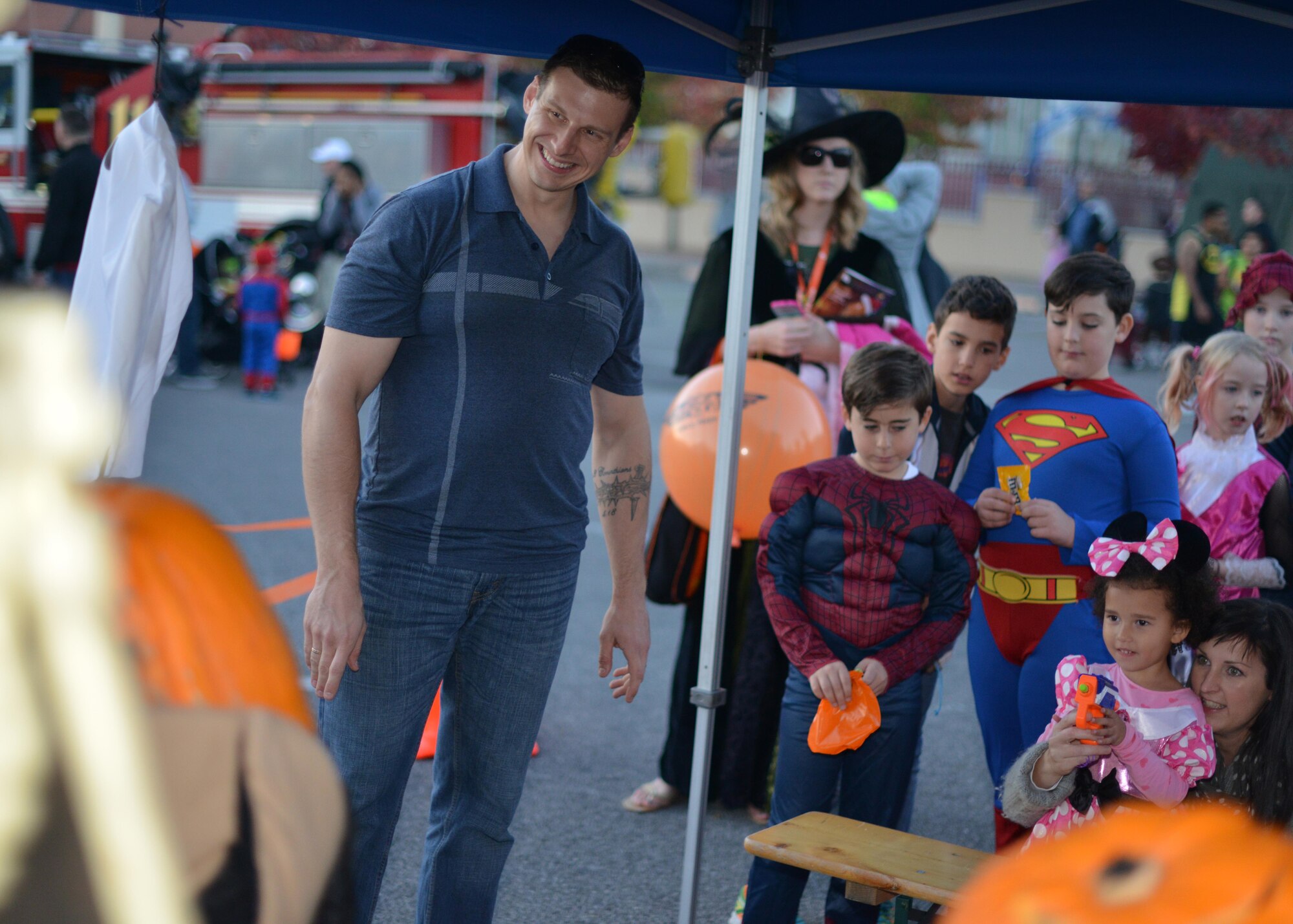 Staff Sgt. Michael Ault, 31st Civil Engineer Squadron explosive ordinance disposal technician, runs an EOD booth at Fall Fest, November 1, 2014, at Aviano Air Base, Italy. Fall Fest offered Department of Defense cardholders and their families a chance to celebrate Halloween in a fun and safe environment. While at Fall Fest, families enjoyed trick-or-treat-booths, food stands, a costume parade and carnival games.  (U.S. Air Force photo/Tech. Sgt. Eric Donner)