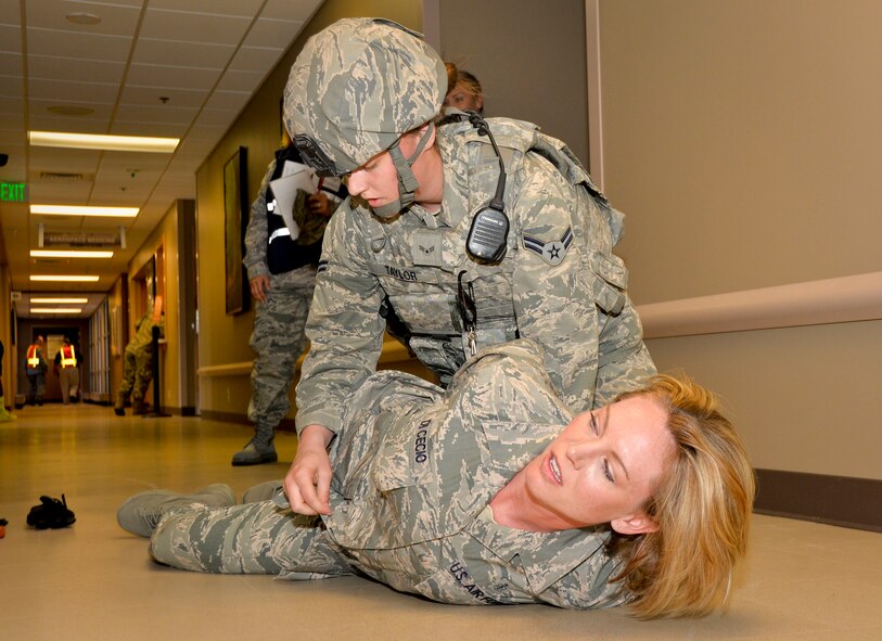 Airman 1st Class Sage Taylor, 2nd Security Forces Squadron installation patrolman, searches a simulated suspect during an active shooter exercise on Barksdale Air Force Base, La., Oct. 26, 2014. Searches are performed to verify that suspects do not have any tools that can harm personnel during transport. (U.S. Air Force photo/Airman 1st Class Mozer O. Da Cunha)
