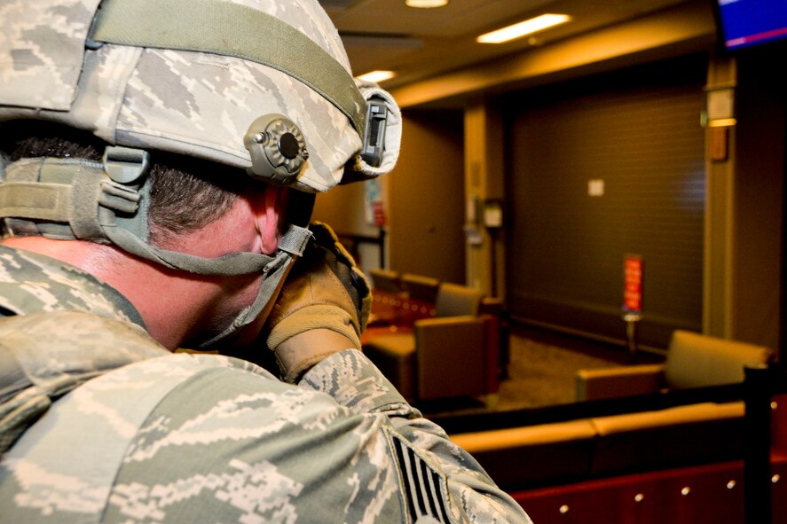 Staff Sgt. Tommy Lester, 2nd Security Forces Squadron emergency response team member, provides cover during an active shooter exercise on Barksdale Air Force Base, La., Oct. 26, 2014. Lester provides cover and overwatch giving other members of his team the capability to move safely in the room. (U.S. Air Force photo/Airman 1st Class Mozer O. Da Cunha)