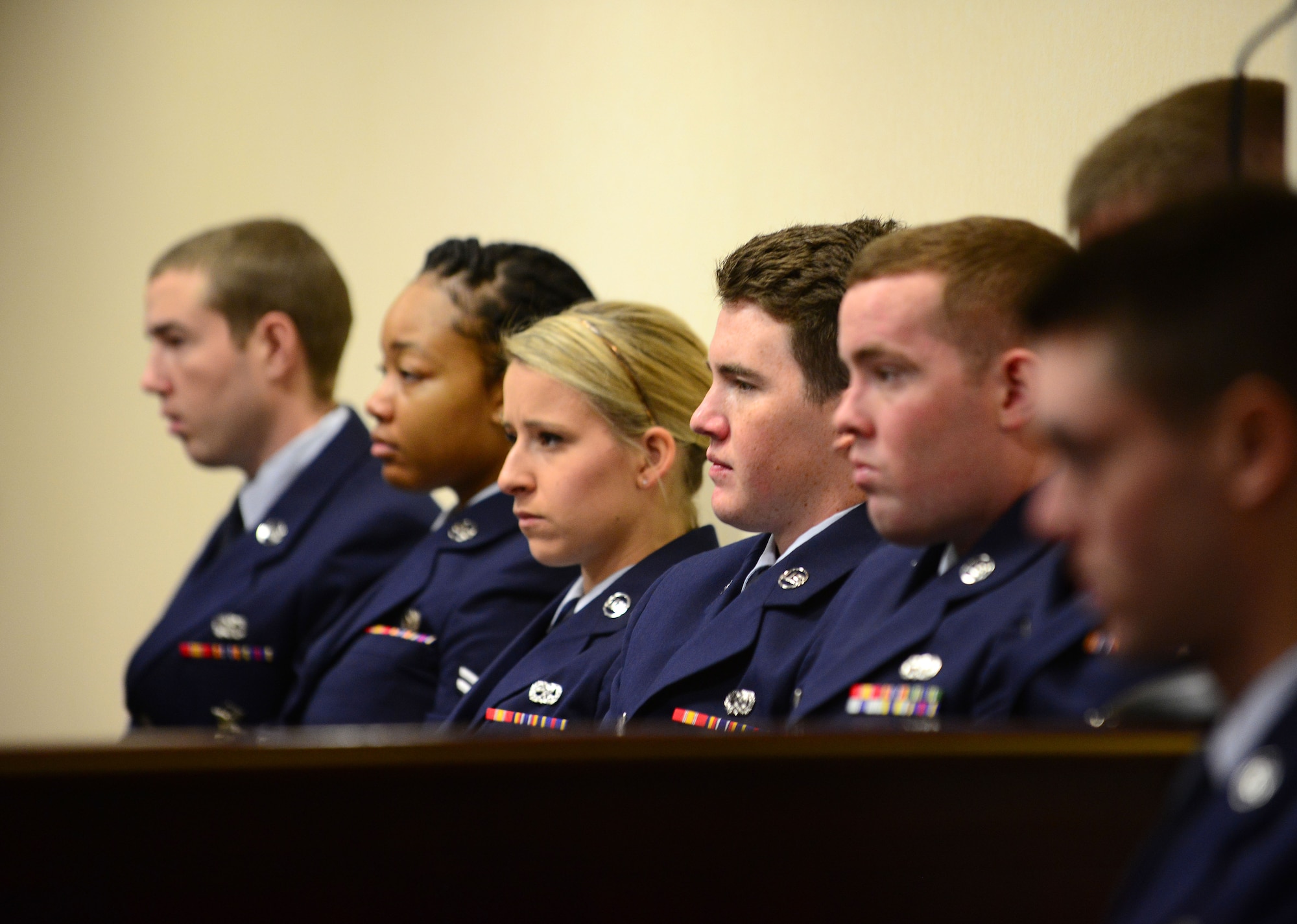 Airmen from the 31st Fighter Wing listen to opening statements during the sexual assault mock trial, Oct. 28, 2014, at Aviano Air Base, Italy. Airmen sat through a court hearing to learn the judicial process of a sexual assault trial. (U.S. Air Force photo/Senior Airman Matthew Lotz)