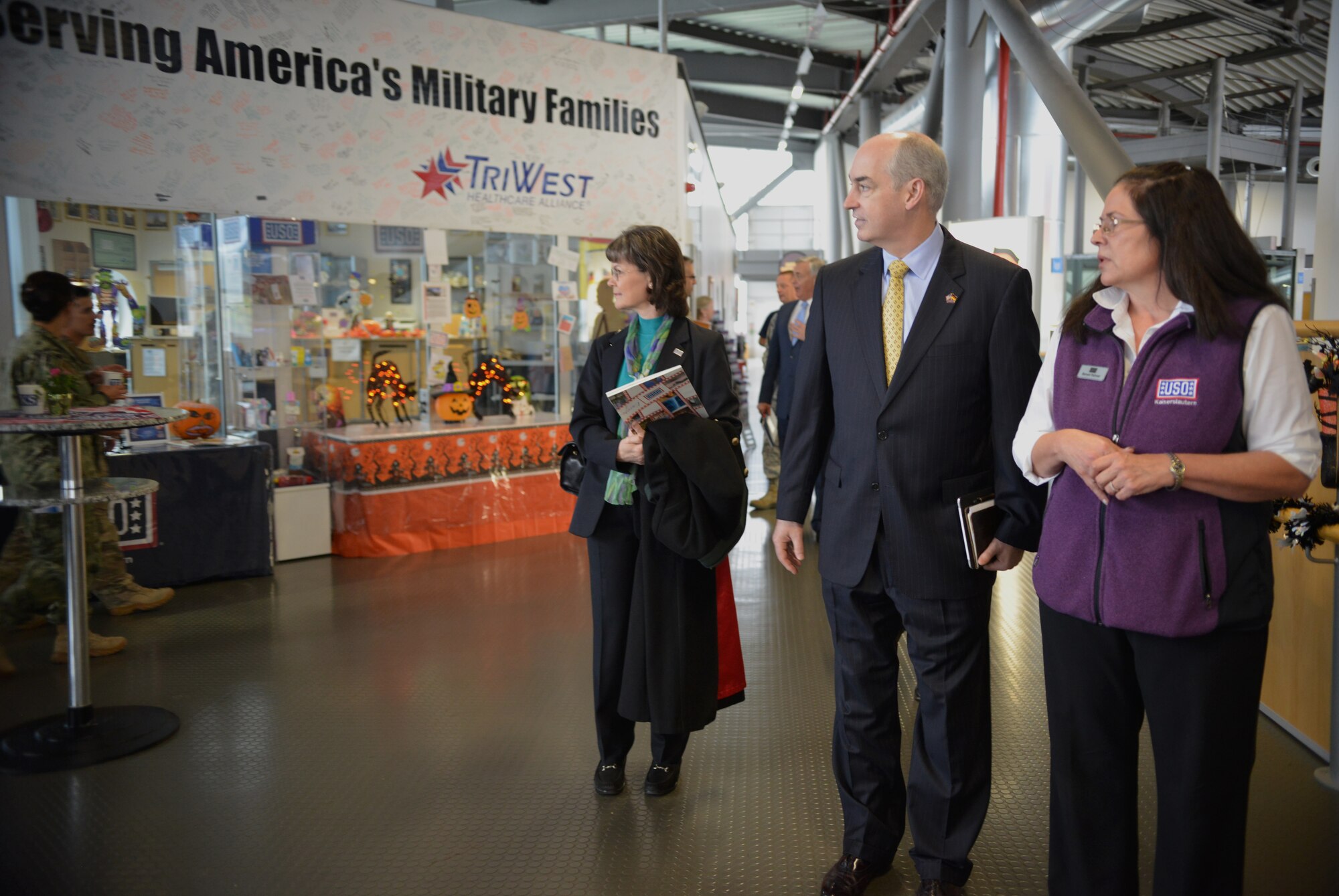 Dr. J.D. Crouch (center), USO’s president and CEO, takes a tour of the USO at the Ramstein Passenger Terminal at Ramstein Air Base, Germany, Oct. 28, 2014. Crouch and his wife came to Ramstein to visit different USOs in the region. (U.S. Air Force photo/Senior Airman Hailey Haux)