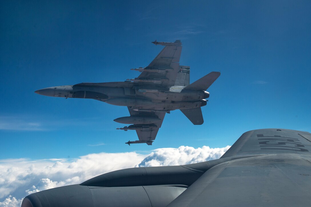 Royal Canadian Air Force CF-18 Hornets breakaway after refueling with a KC-135 Stratotanker aircraft over Iraq, Oct. 30, 2014.
