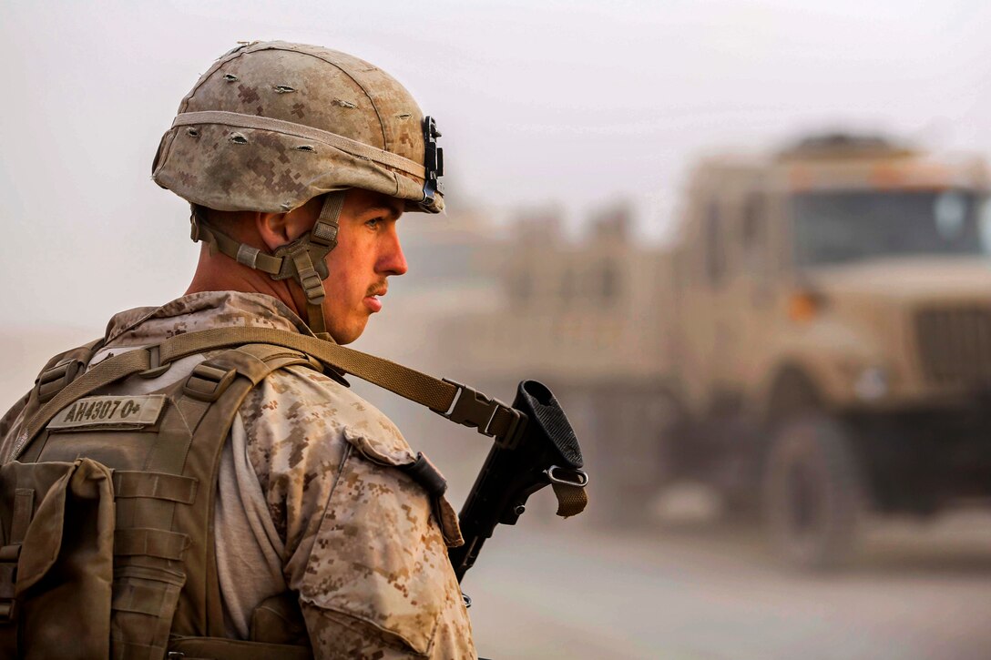 U.S. Marine Corps Lance Cpl. Anthony Huthmacher watches as Afghan soldiers arrive on Camp Leatherneck, Helmand province, Afghanistan, Oct. 27, 2014. Huthmacher is a rifleman assigned to Alpha Company, 1st Battalion, 2d Marine Regiment. The Afghan soldiers took command of all posts on Camp Leatherneck as coalition forces and Marines departed following the end of Regional Command Southwest’s operations in Helmand province.