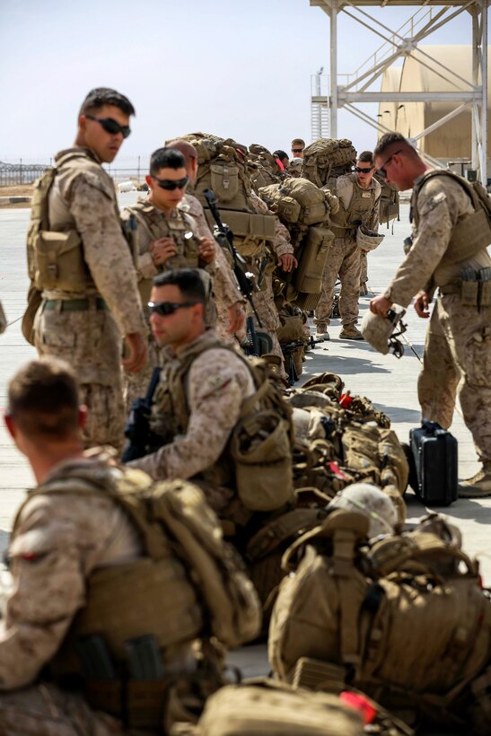 U.S. Marines wait to depart from Bastion Airfield in Helmand province ...