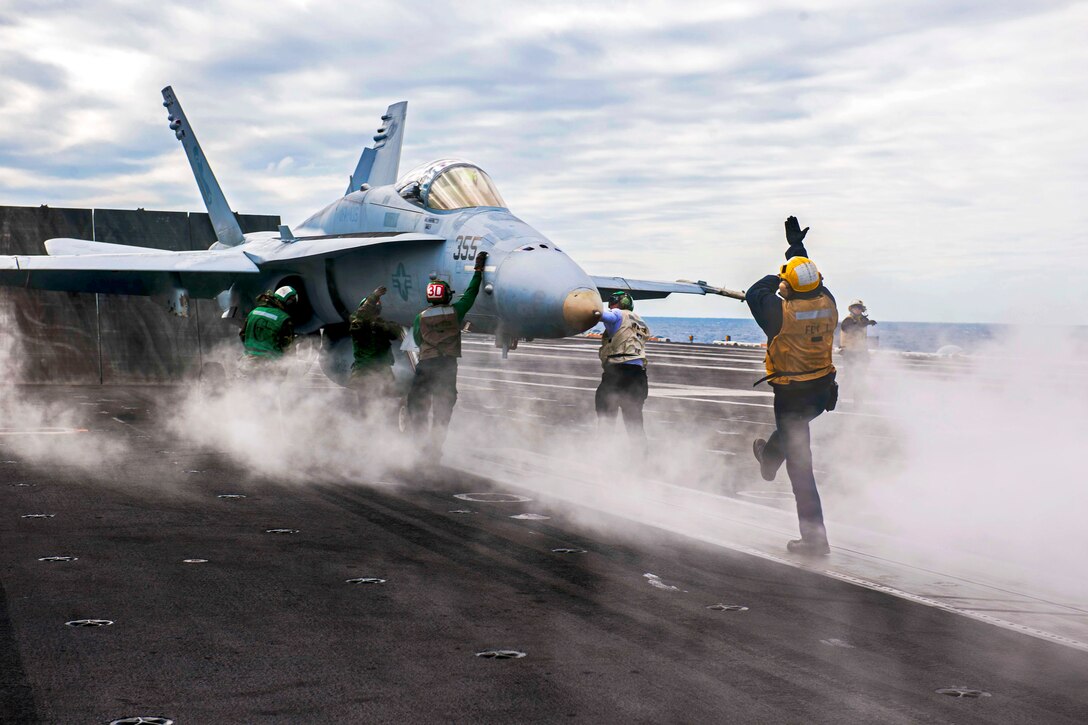 An F/A-18 Hornet assigned to Strike Fighter Attack Squadron 106 prepares to launch from the flight deck of the aircraft carrier USS Theodore Roosevelt