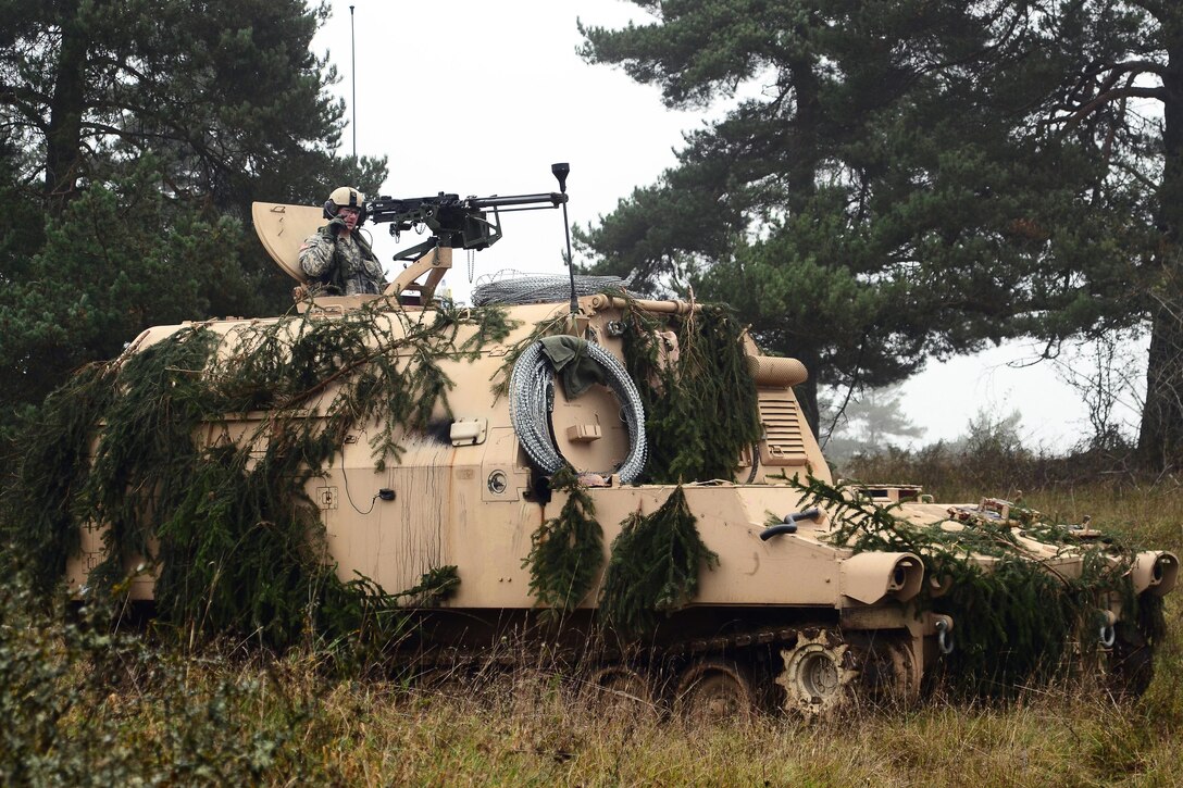 A U.S. soldier communicates on a radio from an M992A2 field artillery ammunition supply vehicle during exercise Combined Resolve III on Hohenfels Training Area, Germany, Oct. 25, 2014.