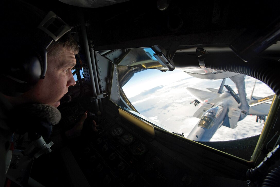Air Force Tech. Sgt. Bill Paull refuels a U.S. Air Force F-15E Strike Eagle from a KC-135 Stratotanker during exercise Southern Strike 15 near the Combat Readiness Training Center in Gulfport, Miss., Oct. 28, 2014. Paull is a boom operator assigned to the Pennsylvania Air National Guard's 171st Aerial Refueling Wing. 