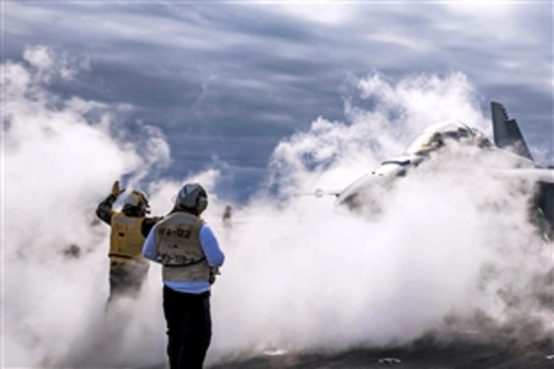 An F/A-18 Super Hornet, assigned to Strike Fighter Attack Squadron 106, prepares to launch from the flight deck of the aircraft carrier USS Theodore Roosevelt during carrier qualifications at sea, Oct. 30, 2014. 