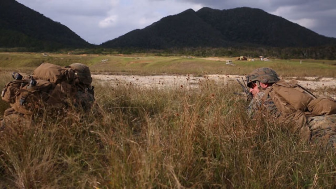 Marines mark and identify targets at their objective Nov. 2 during exercise Blue Chromite 15 in the Central Training Area. Blue Chromite demonstrates the Navy and Marine Corps’ expeditionary capabilities from the sea. Marines rode assault amphibious vehicles in a ship-to-shore assault from the USS Germantown to Oura Wan Beach. After securing their first objective at the beach, Marines advanced inland to the CTA. The Marines are with 2nd Battalion, 9th Marine Regiment, currently assigned to 4th Marines Regiment, 3rd Marine Division, III Marine Expeditionary Force. (U.S. Marine Corps Photo by Lance Cpl. Abbey Perria/Released)