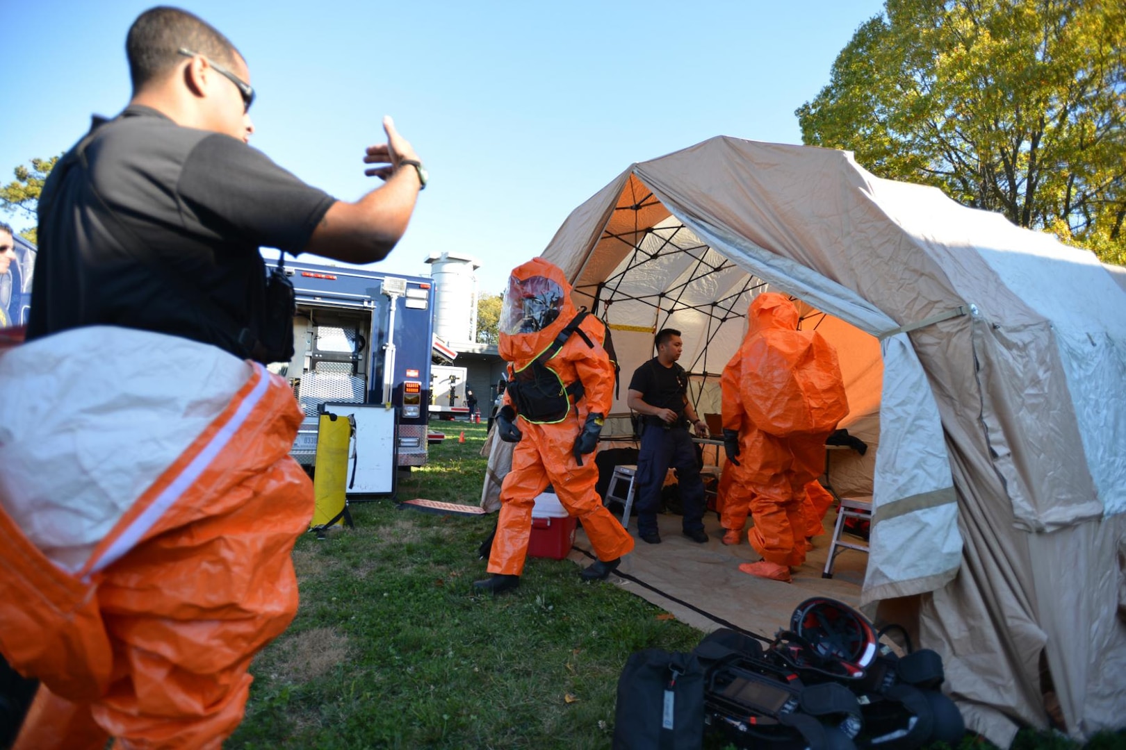 Members of the New York National Guard's 24th Weapons of Mass Destruction Civil Support Team exit the decontamination tent during a drill at the Suffolk County Water Authority's New Highway Pump Station, Oct. 27, 2014. National Guard civil support teams are trained to identify the presence of chemical, biological, or radiological agents and provide that information to local authorities. The exercise tested response protocols to intruder events and to identify and correct any existing weaknesses in station security.