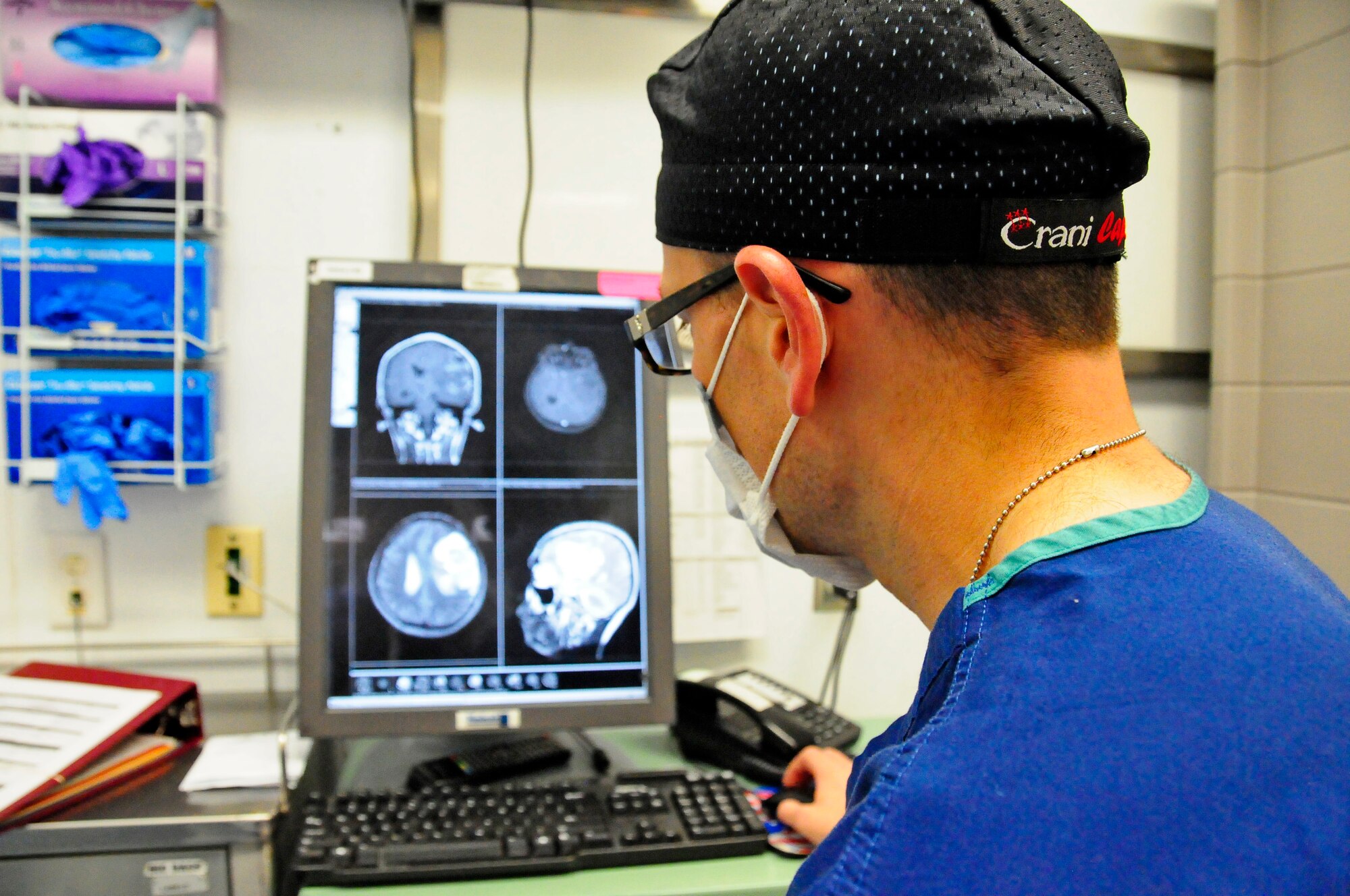 U.S. Air Force Maj Jonathan Forbes, 455 Expeditionary Medical Operations Squadron neurosurgeon reviews magnetic resonance imaging of a patient prior to performing brain surgery at the Craig Joint Theater Hospital, Bagram Airfield, Afghanistan Oct. 10, 2014.  Forbes removed an 8 centimeter tumor in surgery that lasted 5 hours.  Forbes is from Travis Air Force Base, Calif. (U.S. Air Force photo by /Released)