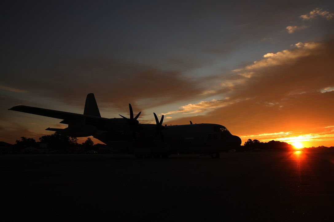 A KC-130J Super Hercules waits for take-off during sunset at Hunter Army Airfield, Ga., Oct. 24, 2014. The Hercules belongs to Marine Aerial Refueler Transport Squadron 252 which performed a detachment flight training to prepare for an upcoming deployment with the Special Purpose Marine Air-Ground Task Force Crisis Response.