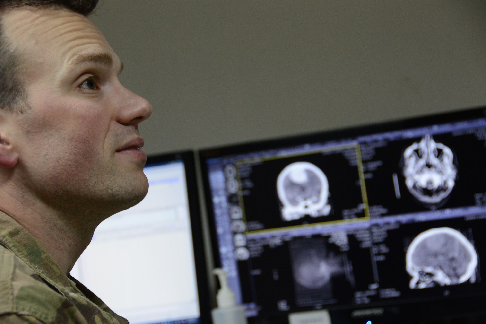 U.S. Air Force Maj. Jonathan Forbes, a neurosurgeon assigned to the 455th Expeditionary Medical Group, listens to a translator during a consultation of an Afghan patient Oct. 22, 2014 while working at the Korean Humanitarian Hospital. Forbes, a native of New Martinsville, West Virginia completed more than 65 surgeries during his six-month deployment. (U.S. Air Force photo by Master Sgt. Cohen A. Young/Released)