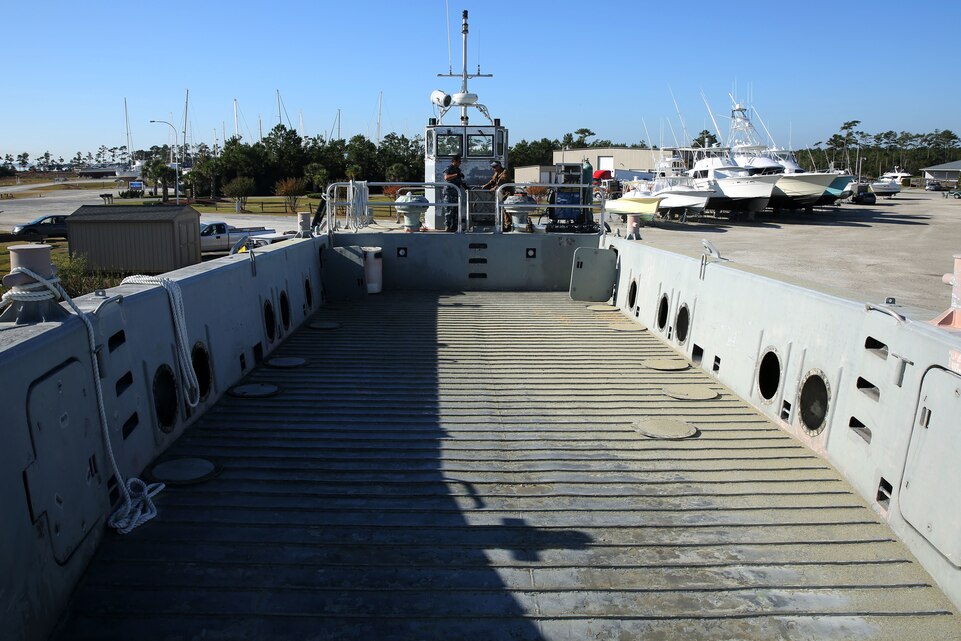 Sailors and civilian contractors work together to maintain a Landing Craft Mechanized-8 boat at Jarrett Bay Boatworks ship yard, Beaufort, N.C., Oct. 28, 2014. Marine Corps Air Station Cherry Point has two LCM-8s which are used to transport cargo and personnel to several air station target ranges. The boats receive scheduled maintenance every two to three years to ensure the vessels can sustain their rigorous workloads.