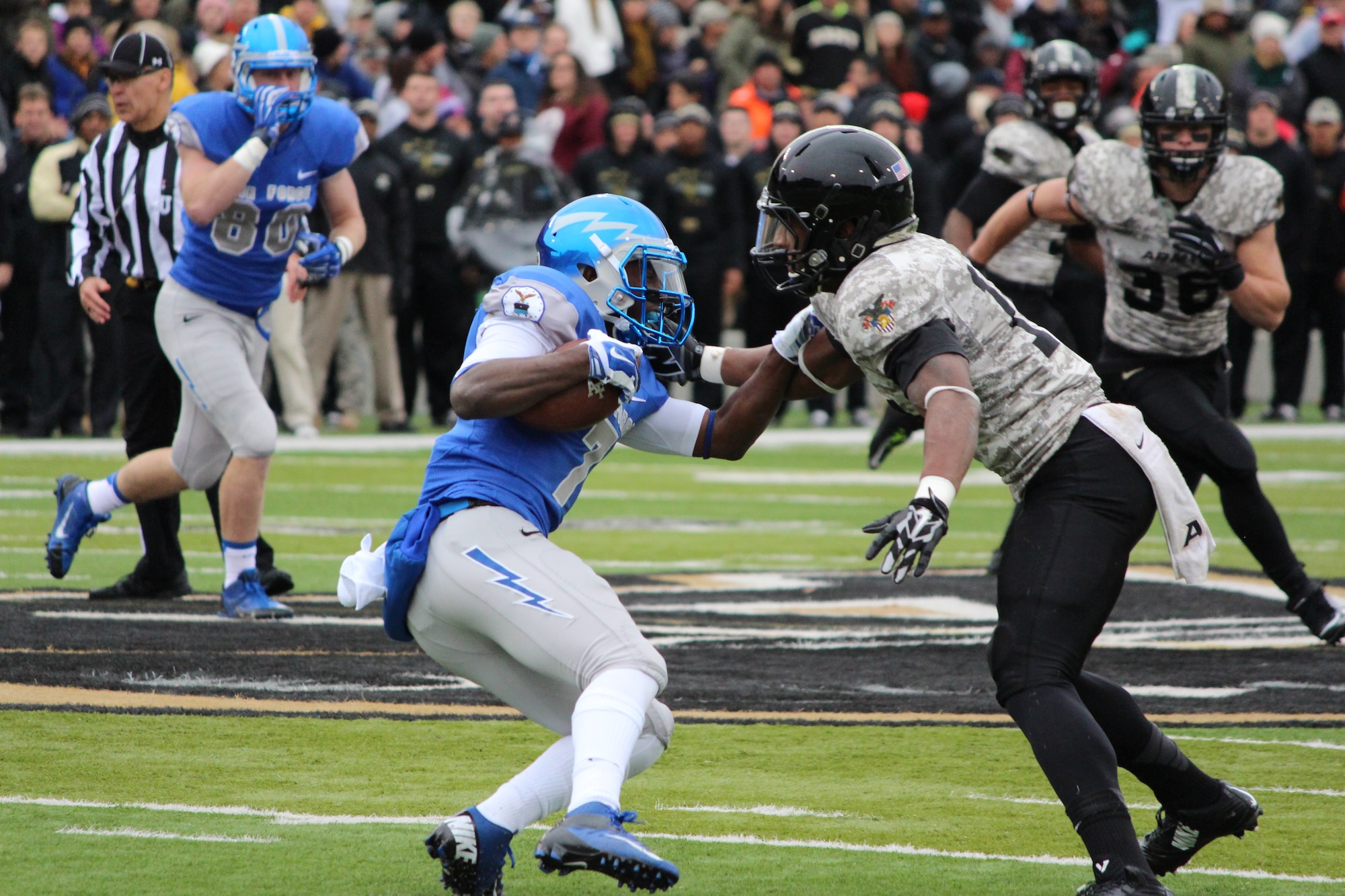 Air Force Falcon wide receiver Garrett Brown tries to elude Army's defense on the field Nov. 1, 2014, at the Falcons vs. Black Knights game at the U.S. Military Academy, N.Y. Air Force won, 23-6, securing the Commander-in-Chief's Trophy for the 19th time. Brown, an Academy junior, ran two catches for 54 yards and had four rushes for a total of nine yards. (U.S. Air Force photo/Cadet 3rd Class Alex Lee)