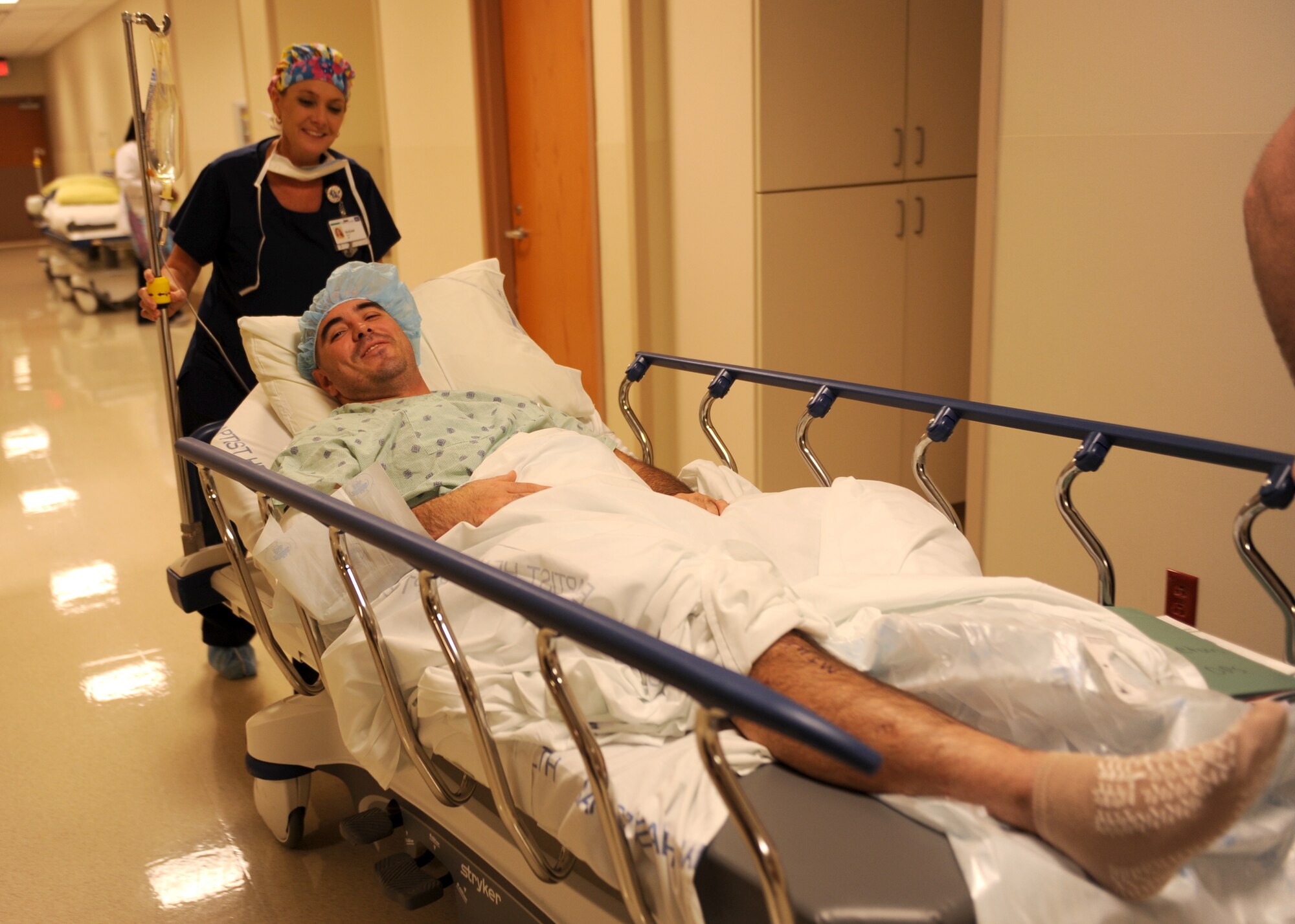 Tech. Sgt. Jason Caswell smiles as he is rolled toward the operating room Oct. 17, 2014, at the Baptist Health Medical Center, Little Rock, Ark. Caswell’s hopes of making the Air Force rugby team never became a reality because of an injury that will affect him for the rest of his life. Caswell is a 19th Aircraft Maintenance Squadron crew chief. (U.S. Air Force photo/Airman 1st Class Scott Poe)