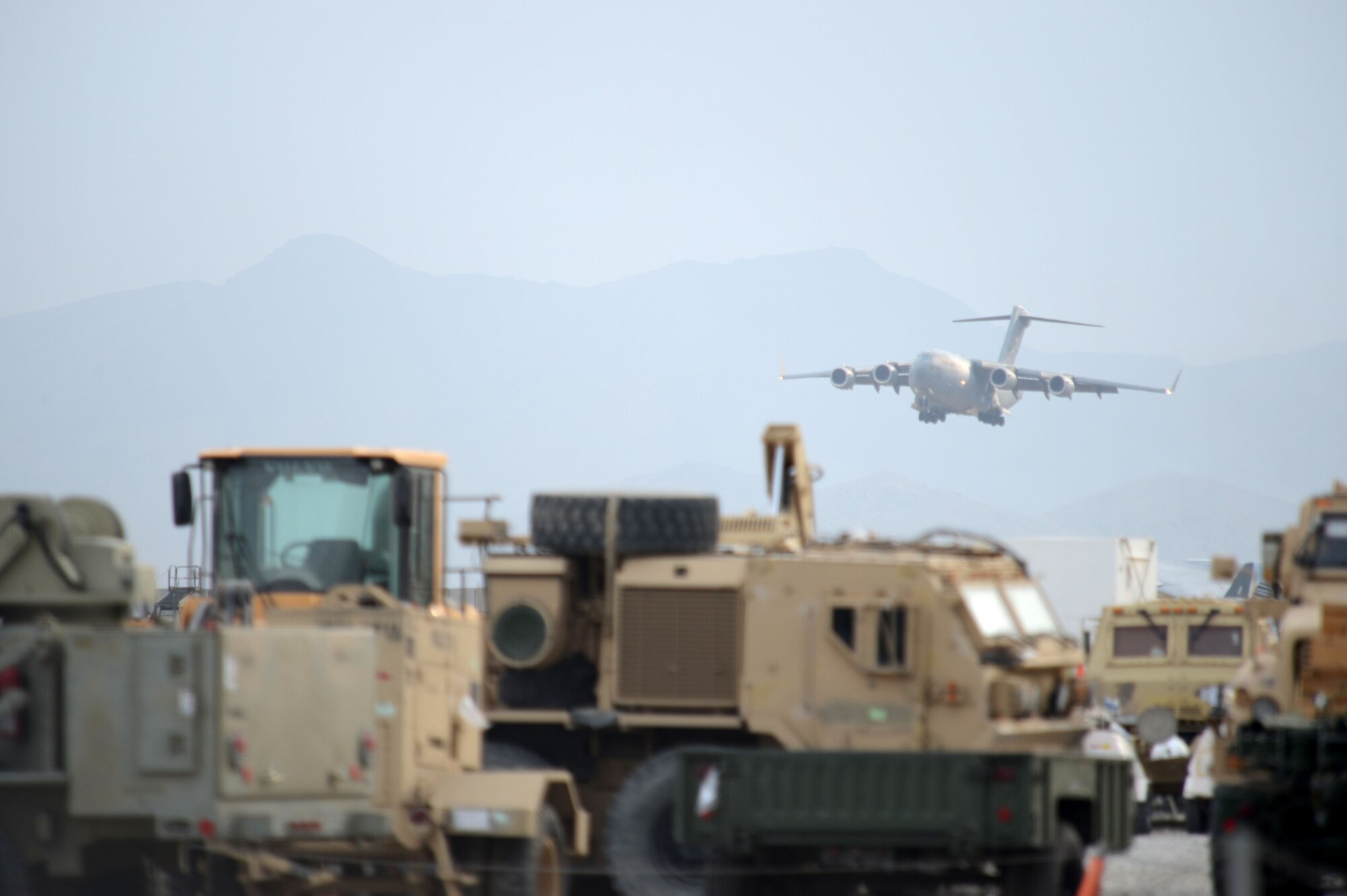 A C-17 Globemaster III descends for landing at Bagram Airfield, Afghanistan Nov. 2, 2014. The men and women of Bagram Airfield service the Department of Defense’s busiest single runway. Airmen and civilian contractors work 24 hours a day, seven days a week to ensure airfield operations are successfully accomplished. (U.S. Air Force photo by Master Sgt. Cohen A. Young/Released)