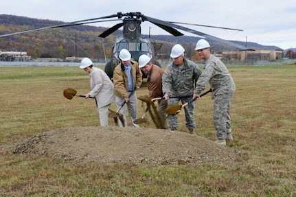 State Rep. Rose Marie Swanger, Eugene J. McNally III, president of Senate Builders, Mark W. Kindig of Leidos Engineering, Maj. Gen. Wesley Craig, Pennsylvania adjutant general, and Col. Todd Levendoski, commander of Eastern Army National Guard Aviation Training Site (EAATS) facility, participated in a groundbreaking ceremony Oct. 31, 2014, for the construction of a new aviation maintenance instruction building. 