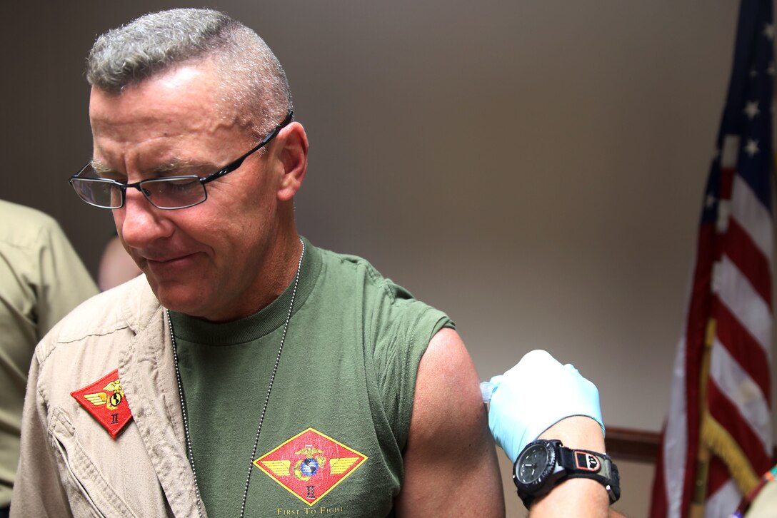 Maj. Gen. Robert F. Hedelund receives his his annual flu shot at the Naval Health Clinic aboard Marine Corps Air Station Cherry Point, N.C., Oct. 31, 2014. Hedelund is the commanding general for the 2nd Marine Aircraft Wing.