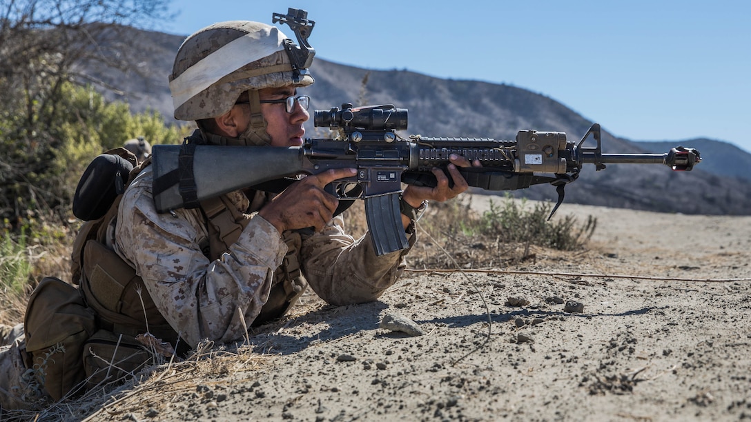 U.S. Marine Pvt. Miguel Garcia provides security during a vertical-assault raid course aboard Camp Pendleton, Calif., Oct. 29, 2014. Garcia, 23, is from Houston, and is a rifleman Lima Company, Battalion Landing Team 3rd Battalion, 1st Marine Regiment, 15th Marine Expeditionary Unit. The course teaches vertical assault techniques and the importance of working together as a cohesive unit during a raid. 