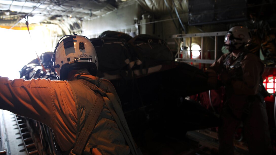 Master Sgt. James R. Holdaway, left, and Staff Sgt. Christopher Maxheimer prepare to release two stacked Combat Rubber Raiding Craft during an aerial delivery mission at Hurlburt Air Force Base, Fla., Oct. 24, 2014. The aerial delivery was conducted in support of United States Special Operations Command. Holdaway and Maxheimer are both crew masters with Marine Aerial Refueler Transport Squadron 252. Holdaway is native of Manassas, Va.,  and Maxheimer is native of Mount Pulaski, Ill.
