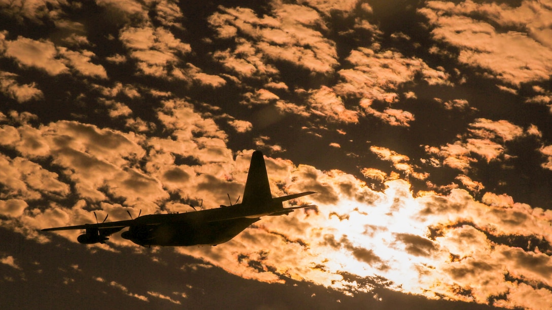 A KC-130J Super Hercules flies beneath the clouds toward Hurlburt Air Force Base, Fla., to conduct an aerial delivery and insertion with United States Special Operations Command Oct. 24, 2014. The Hercules belongs to Marine Aerial Refueler Transport Squadron 252. Along with aerial deliveries, the squadron provides a variety of capabilities in support of the Marine Air-Ground Task Force.