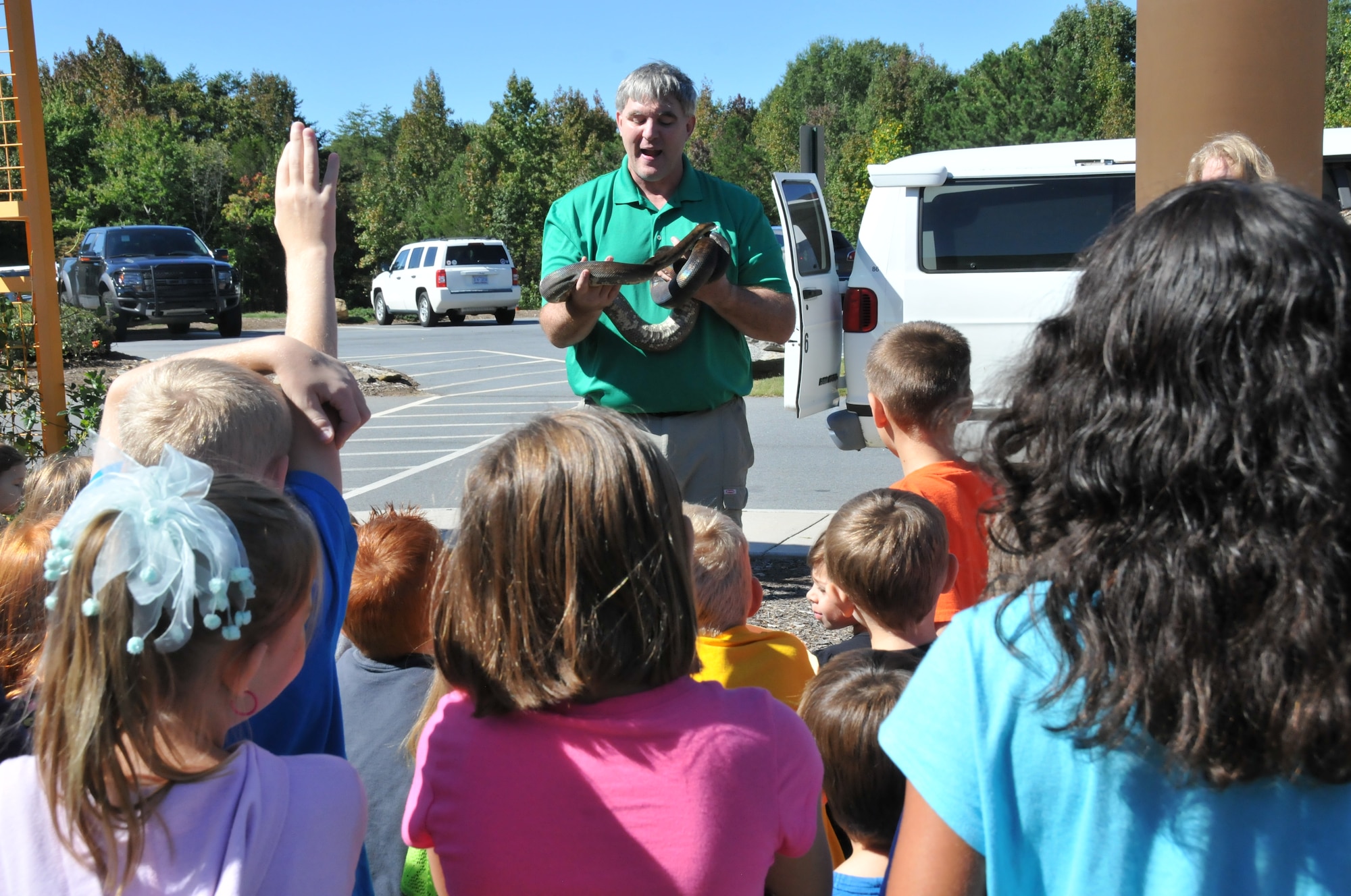 Children look on as a zookeeper shows a snake Oct. 4 at the North Carolina Zoo, Charlotte, N.C. More than 300 Airmen and family members from the 24th Special Operations from Fort Bragg were hosted by Operation Resolute for a day of fun and fellowship there. (U.S. Air Force photo by Maj. Lisa Ray/Released)