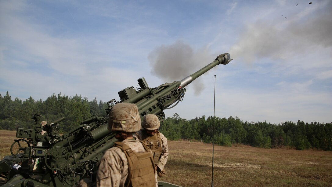 Artillery Marines with Battery A, Ground Combat Element Integrated Task Force, send rounds down range during a live-fire artillery shoot at Marine Corps Base Camp Lejeune, North Carolina, Oct. 29, 2014. Marines of Battery A conducted a live-fire artillery shoot, Oct. 28-30, 2014. From October 2014 to July 2015, the GCEITF will conduct individual and collective level skills training in designated ground combat arms occupational specialties in order to facilitate the standards based assessment of the physical performance of Marines in a simulated operating environment performing specific ground combat arms tasks. 