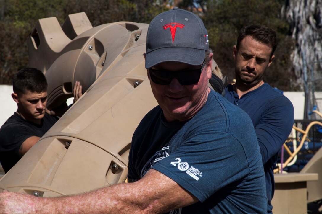 U.S. Marines from the 15th Marine Expeditionary Unit along with local volunteers help load playground equipment near San Clemente, Calif., Oct. 30, 2014. The equipment is provided by the non-profit organization RePlay. RePlay delivers and installs playgrounds in third-world countries. (U.S. Marine Corps photo by Cpl. Elize N. McKelvey/ Released)
