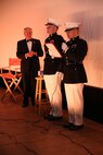 First Lt. Leroy Um, right, adjutant with 9th Marine Corps Recruiting District, reads a letter of appreciation for retired Marine Maj. Donald “Donnie” R. Dunagan, left, during a special movie screening honoring Dunagan at The Pickwick Theater in Park Ridge, Ill., Oct. 30. During Dunagan’s time in the Marines, he received a Bronze Star Medal and three Purple Heart Medals for his service in Vietnam.