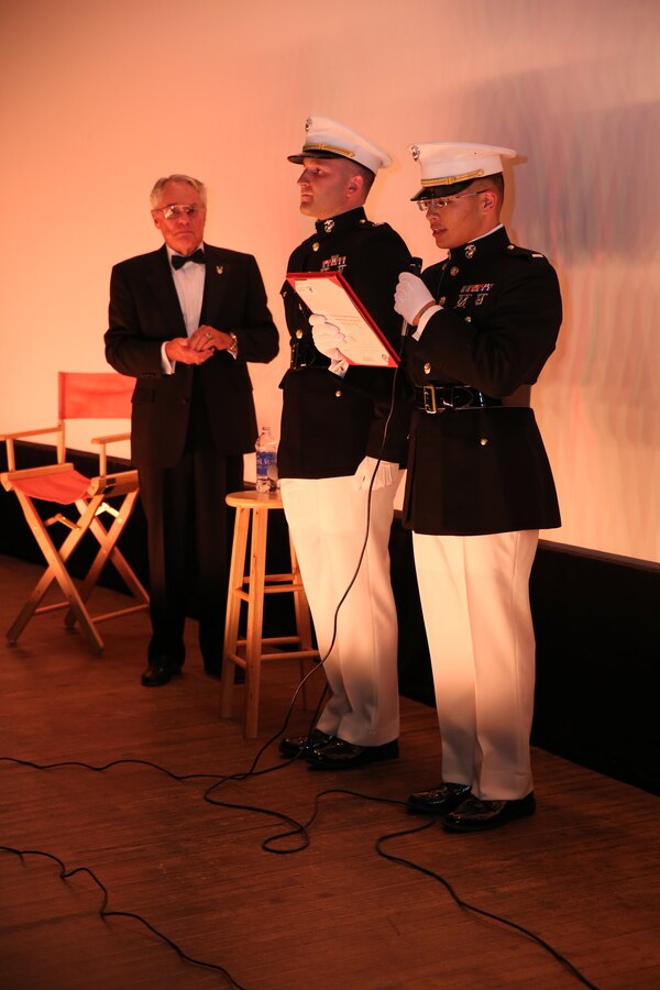 First Lt. Leroy Um, right, adjutant with 9th Marine Corps Recruiting District, reads a letter of appreciation for retired Marine Maj. Donald “Donnie” R. Dunagan, left, during a special movie screening honoring Dunagan at The Pickwick Theater in Park Ridge, Ill., Oct. 30. During Dunagan’s time in the Marines, he received a Bronze Star Medal and three Purple Heart Medals for his service in Vietnam.