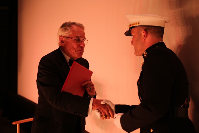 Retired Marine Maj. Donald Dunagan, left, shakes hands with Capt. Jim Stenger, public affairs officer for 9th Marine Corps Recruiting District, after receiving a letter of appreciation from Brig. Gen. James Bierman, commanding general of the Western Recruiting Region, and Col. Jason Morris, commanding officer of 9th Marine Corps District, at The Pickwick Theater in Park Ridge, Ill., Oct. 30. Dunagan is a former child actor and Marine veteran who continues to volunteer his time and efforts to assist military veterans.