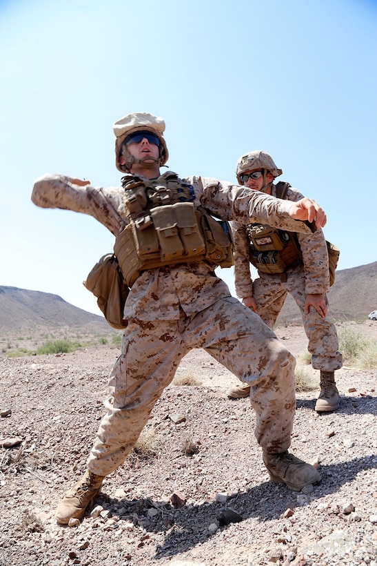U.S. Marine Corps Sgt. Robert J. Scarpello, right, an explosive ordnance disposal technician with Combat Logistics Battalion 11 11th Marine Expeditionary Unit (MEU), and native of Sellersville, Pennsylvania, observes a Marine with CLB-11, 11th MEU, throwing an M69 practice grenade as part of sustainment training at D’Arta Plage, Djibouti, Nov. 1. The 11th MEU is deployed as a theater reserve and crisis response force throughout U.S. Central Command and the U.S. 5th Fleet area of responsibility. (U.S. Marine Corps photos by Gunnery Sgt. Rome M. Lazarus/Released) 
