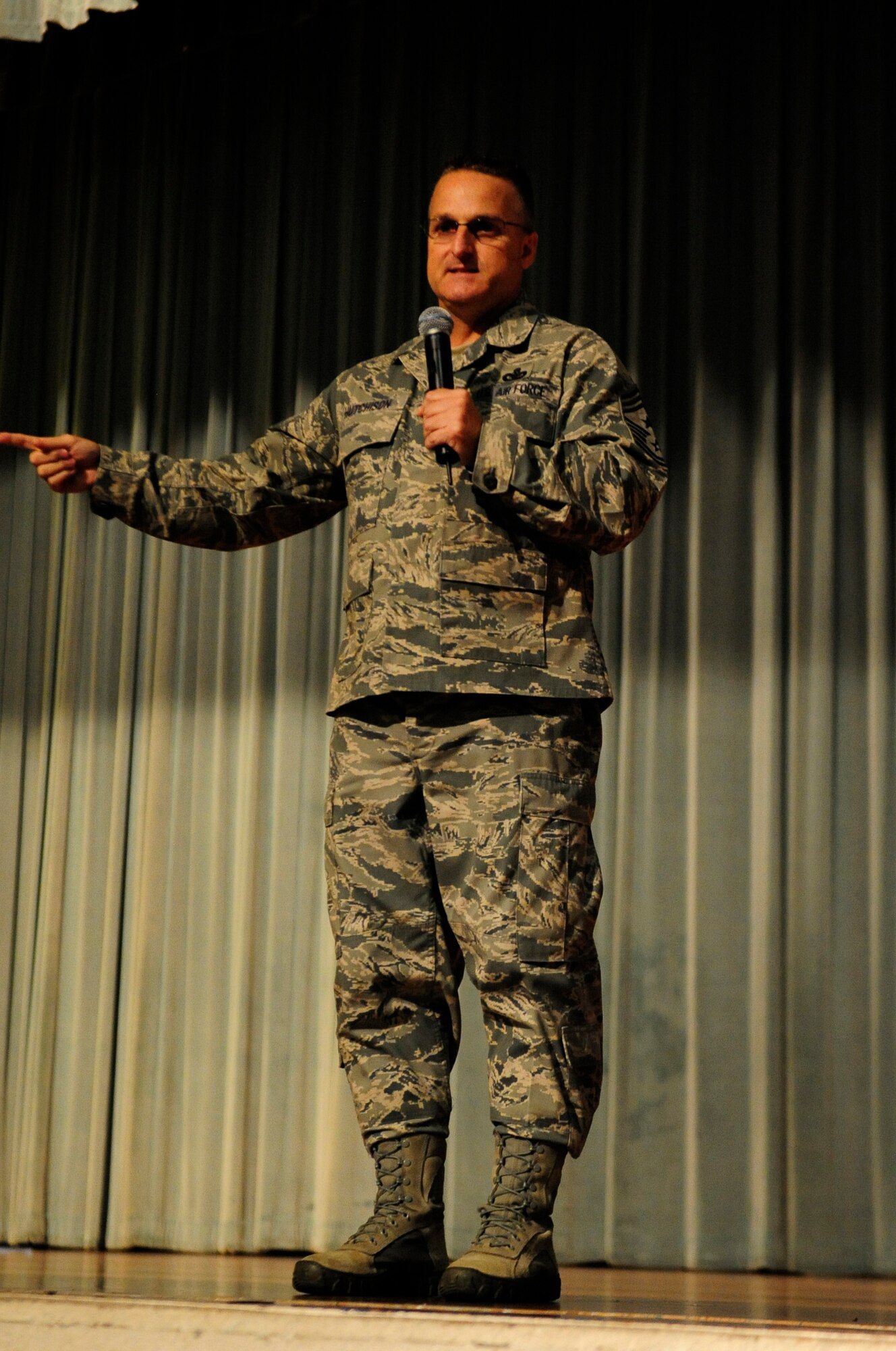 U.S. Air Force Chief Master Sgt. Harold Hutchison, Pacific Air Forces command chief, speaks to Airmen of the 18th Wing during an enlisted all-call on Kadena Air Base, Japan, Oct. 28, 2014. During the all-call Hutchison addressed the new changes in today's Air Force to include enlisted performance report changes, Developmental Special Duties, and the Airman innovative program. Hutchison ended with a question and answer session to find out what is affecting today's Airmen. (U.S. Air Force photo by Airman 1st Class Keith James/Released)